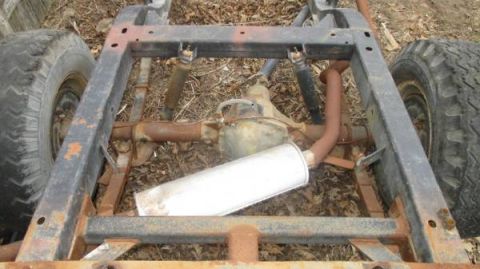 1991 Ford Bronco - Frame and rear axle assembly of a vehicle, showing exhaust and suspension components.