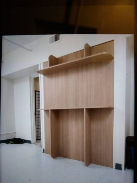 1991 Ford Bronco - A built-in shelving unit with a light wood finish is shown in a room.