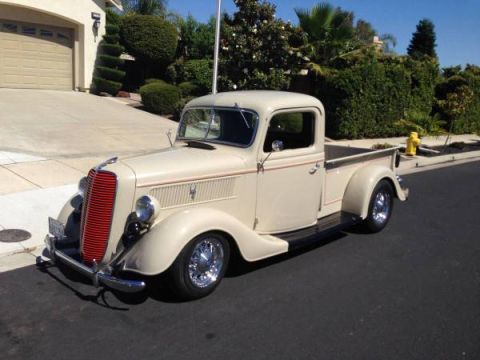 1991 Ford Bronco - This vintage pickup truck, likely a 1936 model, is parked in front of a residential garage.