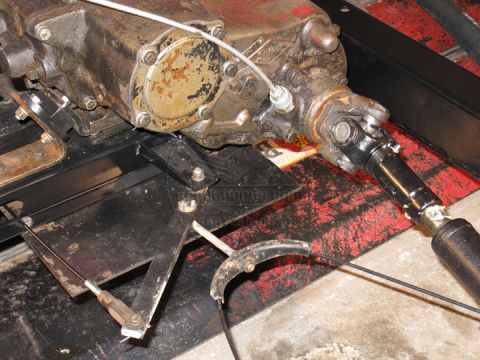 1991 Ford Bronco - Close-up view of a vehicle's transfer case and driveshaft assembly.