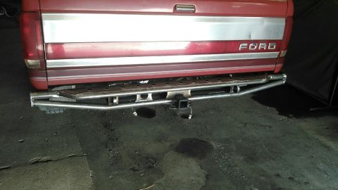 1991 Ford F-150 - Rear view of a red 1991 Ford F-150 pickup truck a custom metal bumper and trailer hitch.