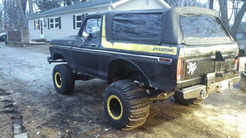 1978 Ford Bronco - This 1978 Ford Bronco is modified with large paddle tires and a yellow stripe reading "OVERTIME".
