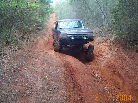1986 Ford Bronco - This 1987 Ford Bronco navigates a challenging off-road course through a forest.