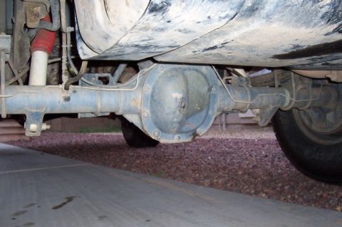 1992 Ford Bronco - The underside of a vehicle shows the rear axle assembly, differential, and suspension parts.