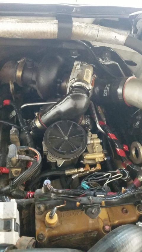 1995 Ford F-250 - Engine bay view showing various components of a diesel engine, including turbocharger and fuel lines.