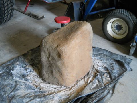1992 Ford Bronco - A large rock sits on a tarp, with a tractor tire visible in the background.