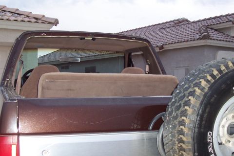 1992 Ford Bronco - Rear view of a 1992 Ford Bronco, showing the interior and spare tire.