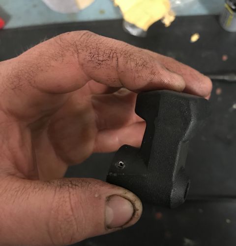 1995 Ford Bronco - A black plastic part is held in a dirty hand, with a website URL visible at the bottom right.