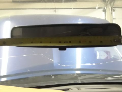 1996 Ford F-350 - Measuring the interior rearview mirror with a tape measure.