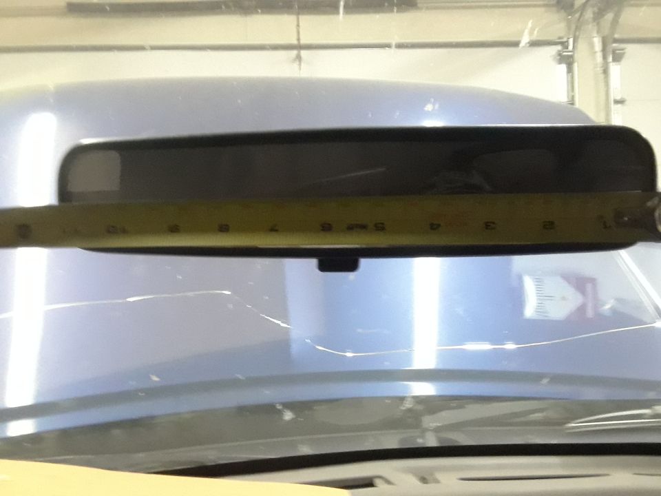 Interior rearview mirror being measured with a tape measure