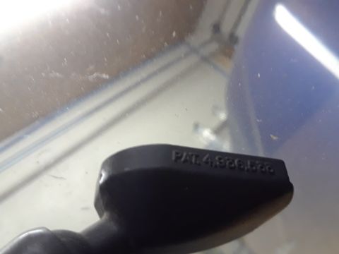 1996 Ford F-350 - A close-up view of a black plastic component displaying a patent number.