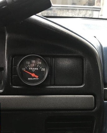 1995 Ford Bronco - An Auto Meter transmission temperature gauge is visible on the dashboard of a vehicle.