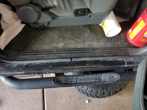 1993 Ford Bronco - Interior view of a vehicle's step bar and tire, with a seat visible.