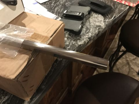 1923 Ford Model T - A chrome trim piece is placed on top of a cardboard box.