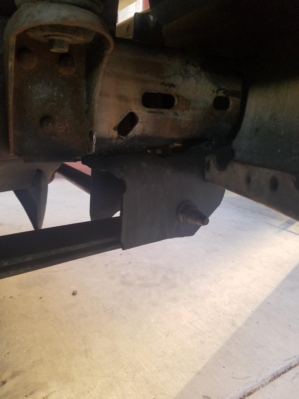 Close-up of vehicle frame and suspension parts, possibly from a truck
