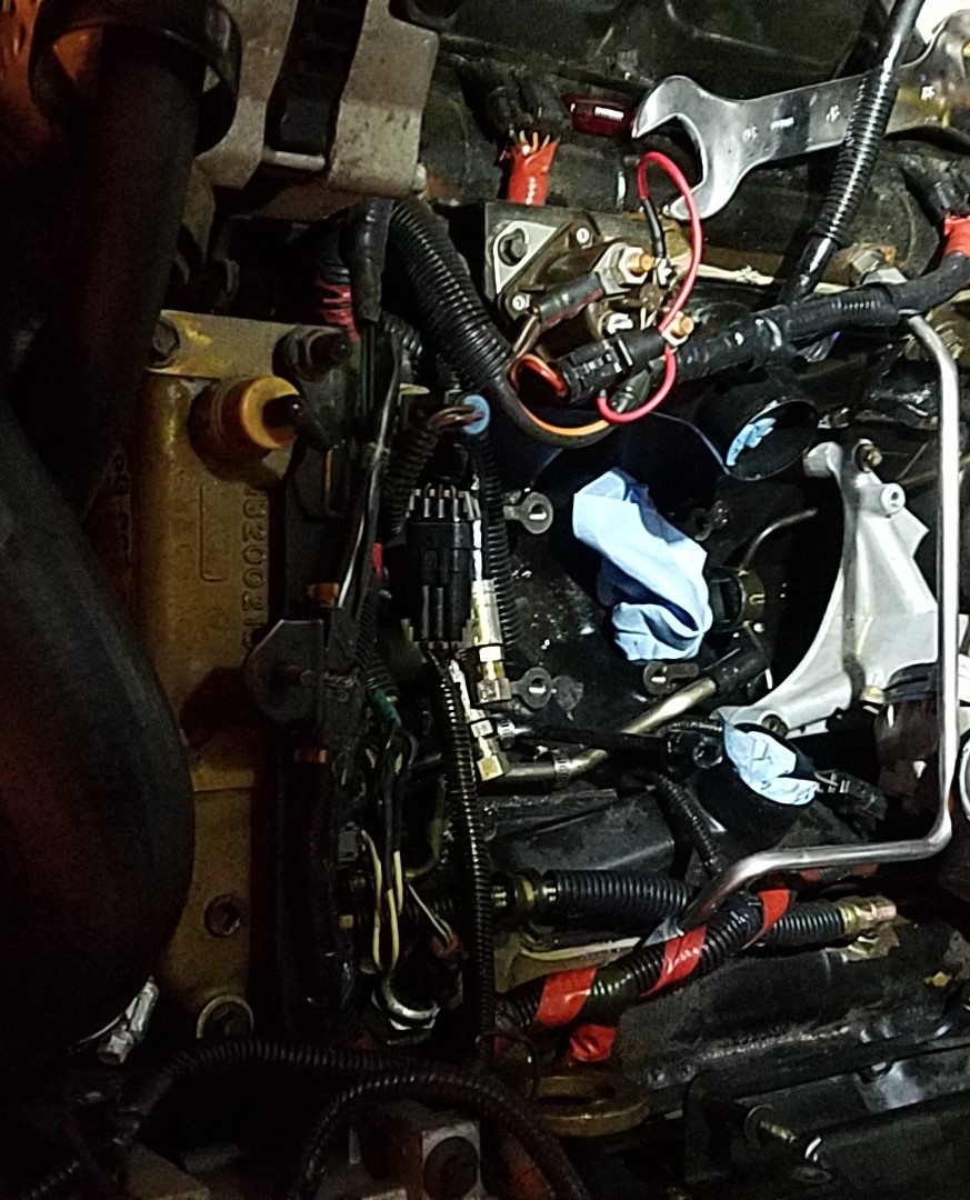 Close-up of diesel engine fuel lines and injectors with some blue shop towels