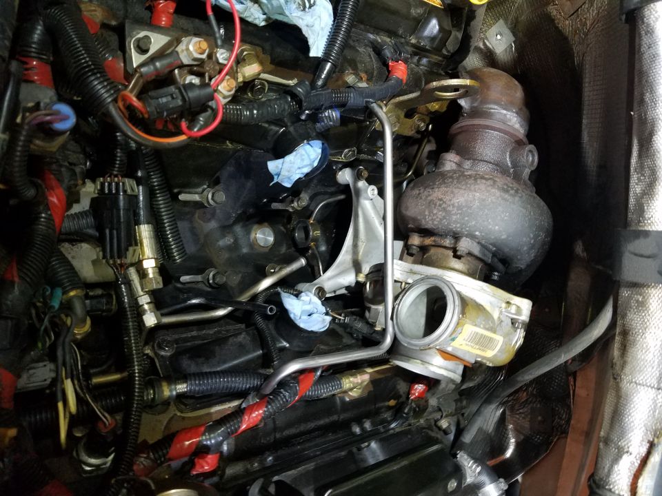 Engine bay with turbocharger and fuel lines. Supermotors.net logo visible