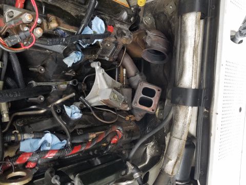 1995 Ford F-250 - Close-up of engine bay components, including turbocharger parts and exhaust system.