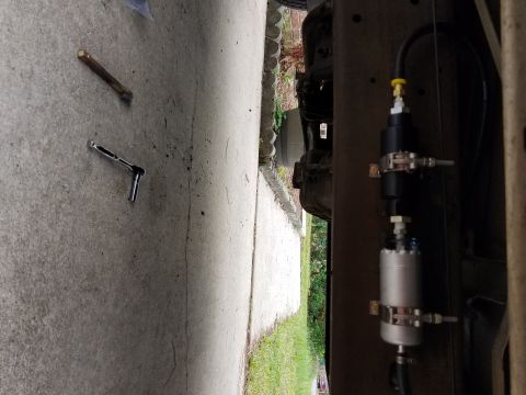 1995 Ford F-250 - Aftermarket fuel filter and pump assembly installation on a vehicle frame rail.