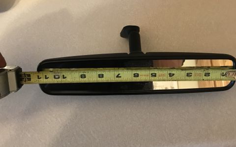 1995 Ford Bronco - A tape measure is used to measure the length of a vehicle's interior rear-view mirror.
