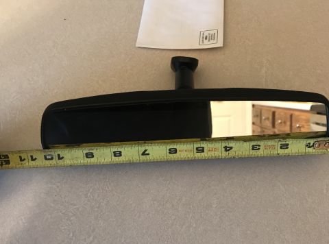 1995 Ford Bronco - An interior rearview mirror is shown alongside a tape measure, indicating its dimensions.