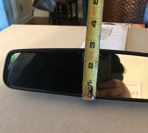 1995 Ford Bronco - Measuring a rear-view mirror with a tape measure. The tape reads approximately 3.5 inches.