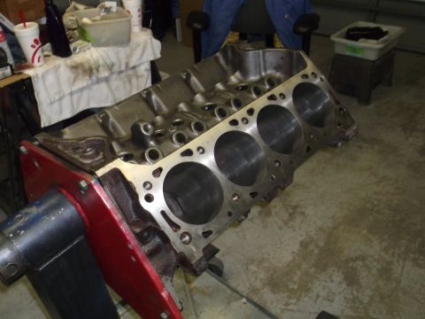 1976 Ford Ranchero - A bare engine block rests on a red stand, ready for assembly or inspection.