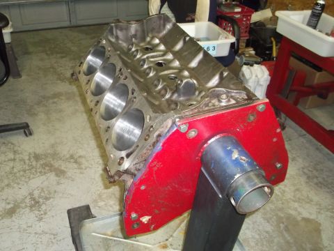 1976 Ford Ranchero - Engine block on a stand, possibly for a Ford Ranchero, with visible text on the bottom right reading 'SUPERMOTORS.NET'.