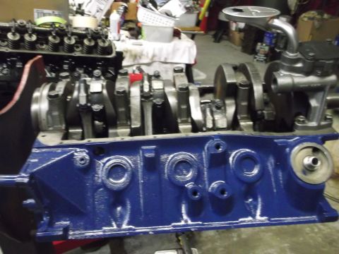 1976 Ford Ranchero - Close-up view of a blue engine block with a visible crankshaft and oil pump assembly, likely undergoing restoration or repair.
