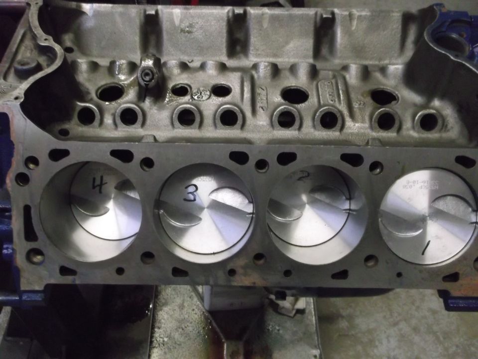 Engine block with pistons numbered 1-4. Text on piston reads 8-01-91