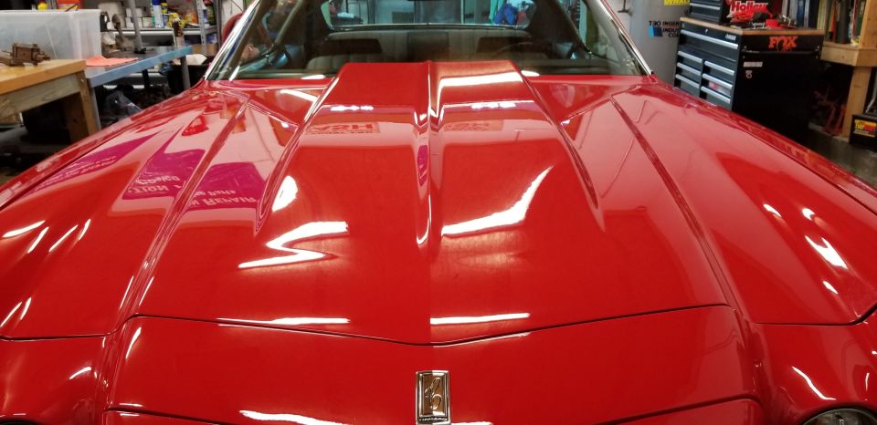 Red 1970 Chevrolet Camaro with a raised hood scoop, front view