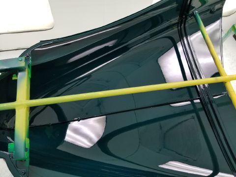 1940 Ford Coupe - Interior of a car door panel, painted dark green, with yellow support bars visible.
