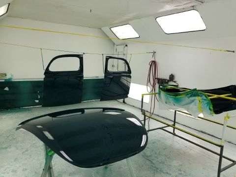 1940 Ford Coupe - Car doors and hood are prepped and painted in a professional booth, awaiting reassembly.