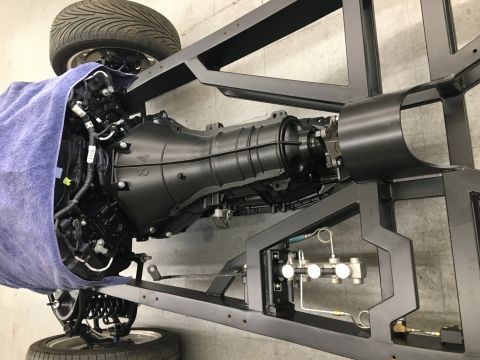 1940 Ford Coupe - Close-up of a vehicle's chassis and transmission assembly, showing suspension parts.