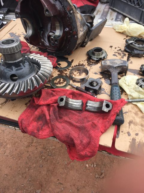 1984 Ford Bronco - Disassembled differential components and tools are spread out, suggesting a repair or rebuild process.