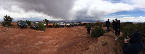 1984 Ford Bronco - A convoy of off-road vehicles gathered on a scenic overlook as a storm approaches.