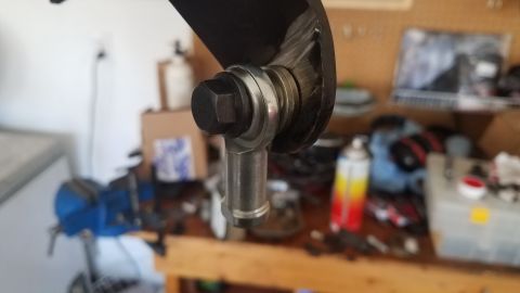 1985 Ford Bronco - A close-up view of a rod end joint, a component often found in automotive steering and suspension systems.