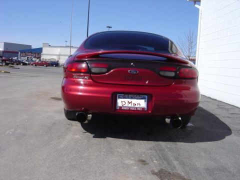1998 Ford Taurus - Rear view of a red 1998 Ford Taurus sedan with a custom license plate.