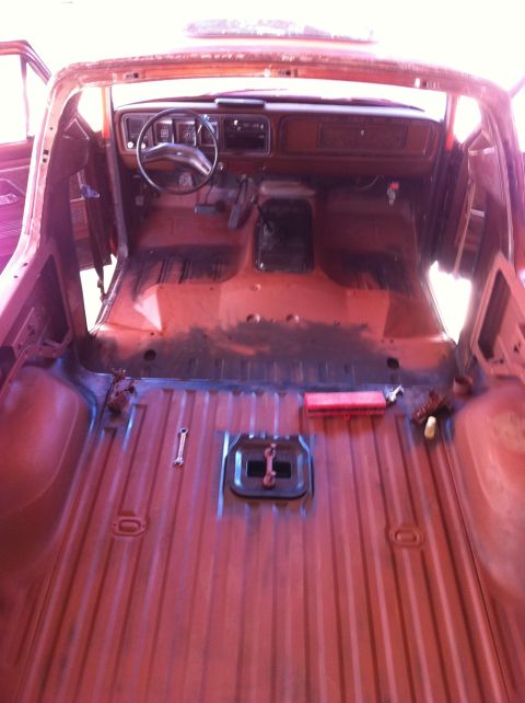 1978 Ford Bronco - The interior of a 1978 Ford Bronco shows a stripped-down bed and cab, ready for restoration.