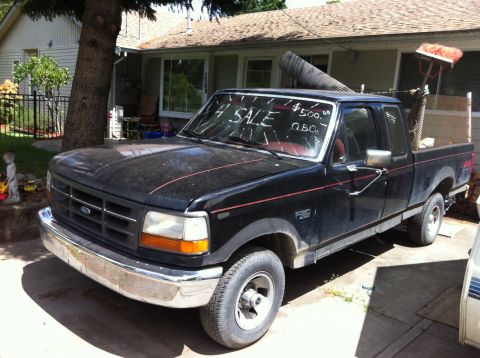 1978 Ford Bronco - This black Ford F-150 pickup truck is for sale with a handwritten sign on the windshield.