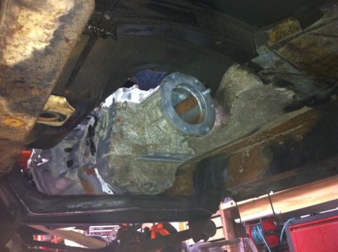 1978 Ford Bronco - Underside view of a vehicle's transmission and frame, with visible rust and mechanical parts.
