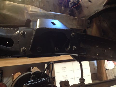 1978 Ford Bronco - This photo shows a custom bracket being installed on a vehicle's frame, indicating a modification is underway.