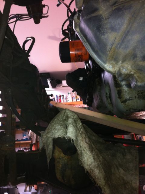1978 Ford Bronco - An orange oil filter is visible, attached to a vehicle's engine components.