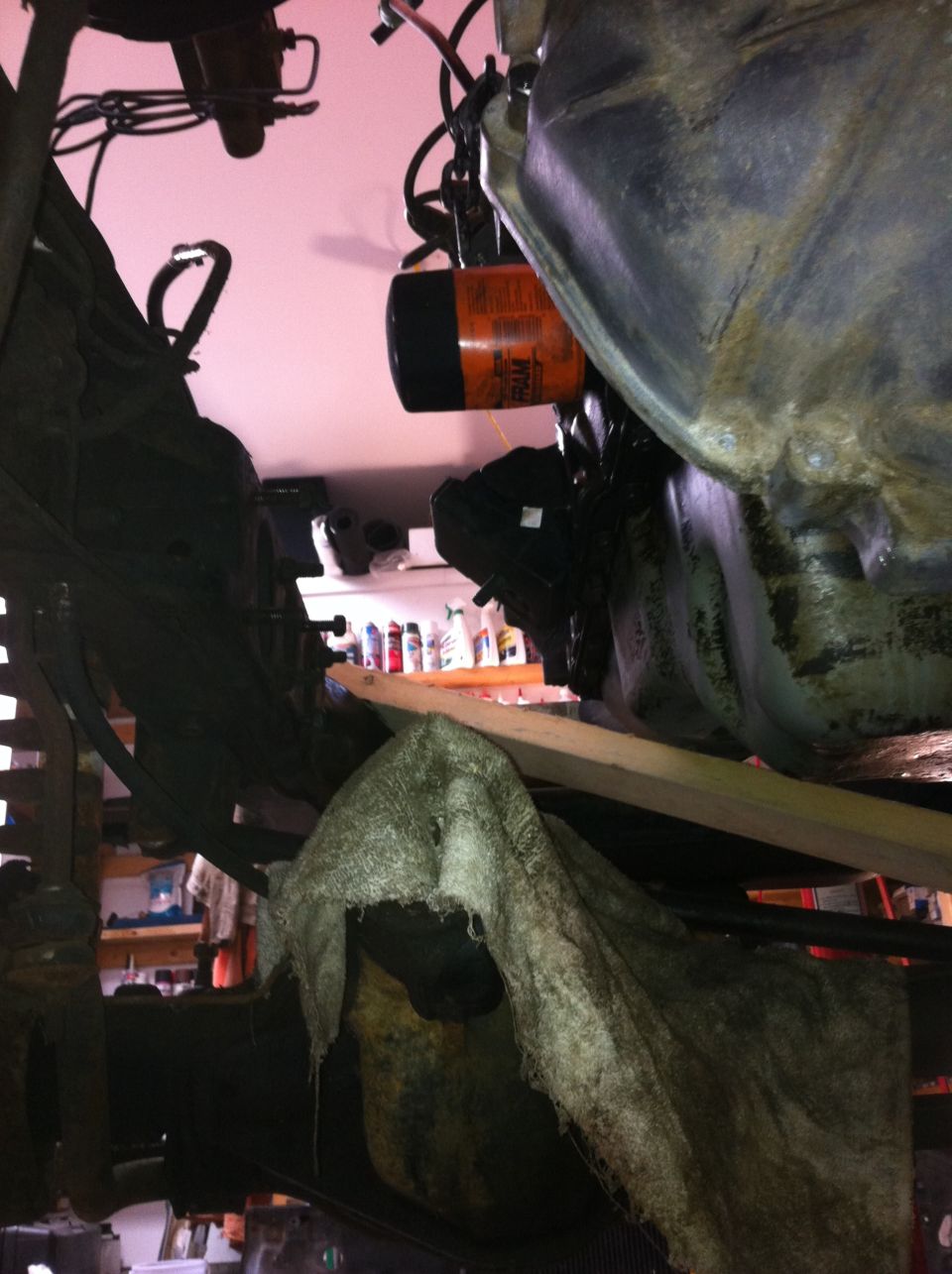 close-up of an orange oil filter attached to an engine component