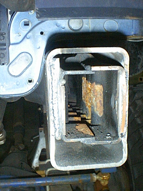 1995 Ford Bronco - A close-up view of a vehicle's frame and hitch receiver shows significant rust and wear.