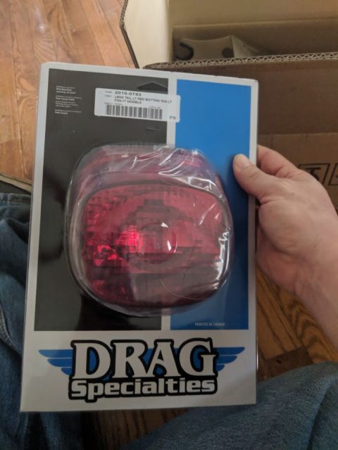 2014 Harley-Davidson FXDWGI Wide Glide - A Drag Specialties tail light is shown in its retail packaging, with a label indicating part number 2010-0785.