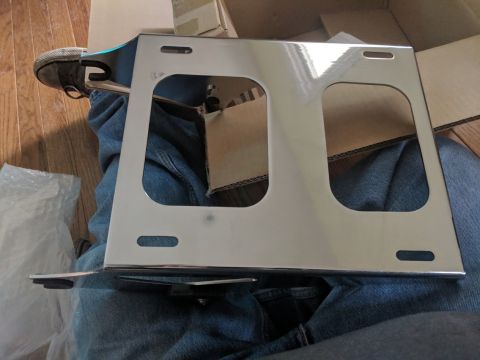 2014 Harley-Davidson FXDWGI Wide Glide - A shiny chrome luggage rack is shown, likely for a motorcycle, with a person's legs visible in the background.