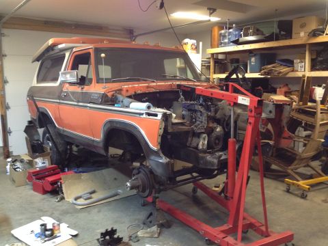 1978 Ford Bronco - Ford Bronco undergoing engine removal and repair in a workshop environment.