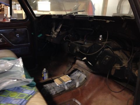 1978 Ford Bronco - The interior of a vehicle is shown with the dashboard disassembled for repairs, presumably, repairs or modifications.