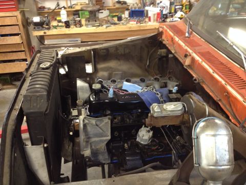 1978 Ford Bronco - The engine bay of a vehicle is shown with the engine partially disassembled and removed for repair.